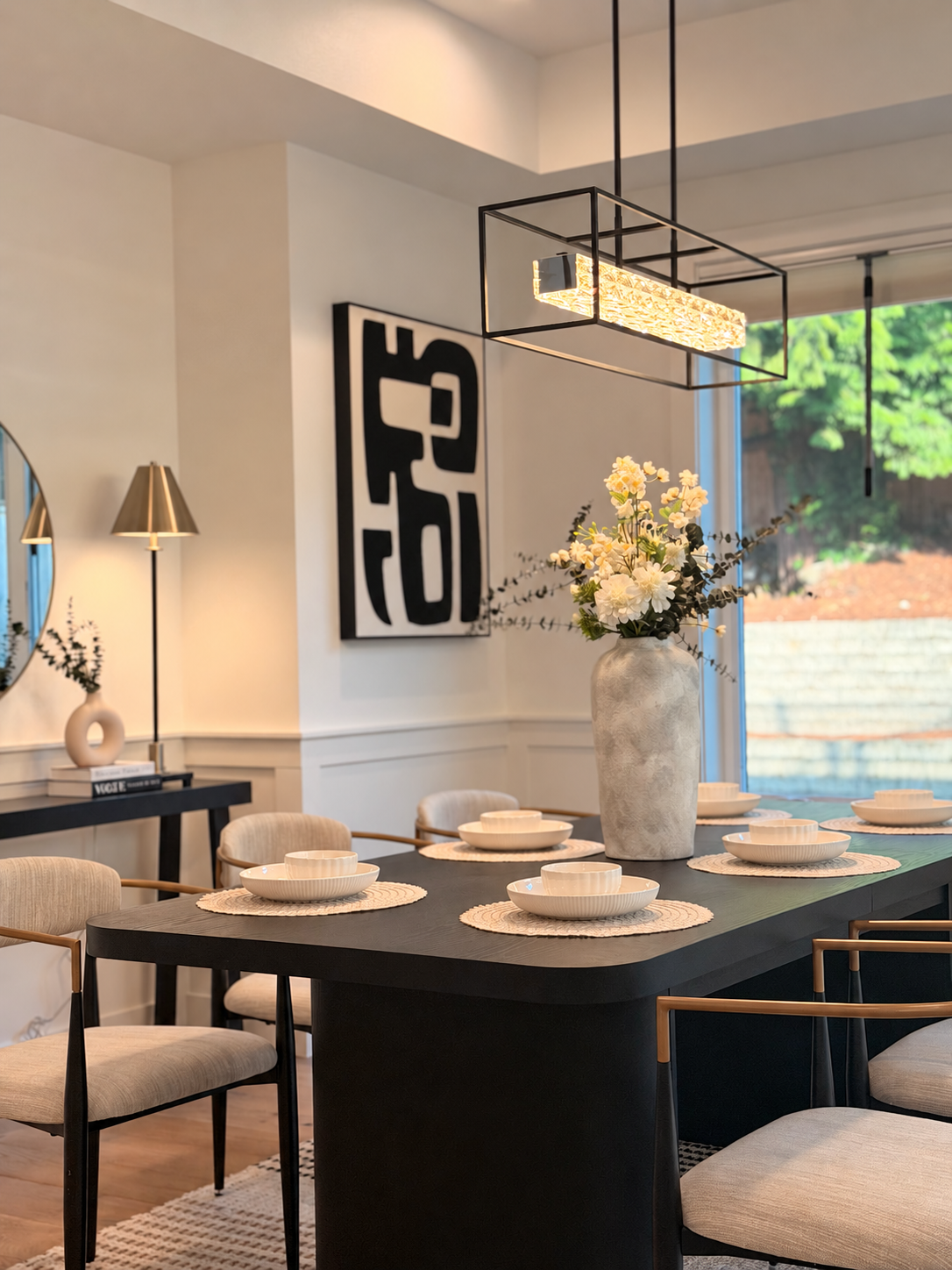 Dining room with black table and floral centerpiece