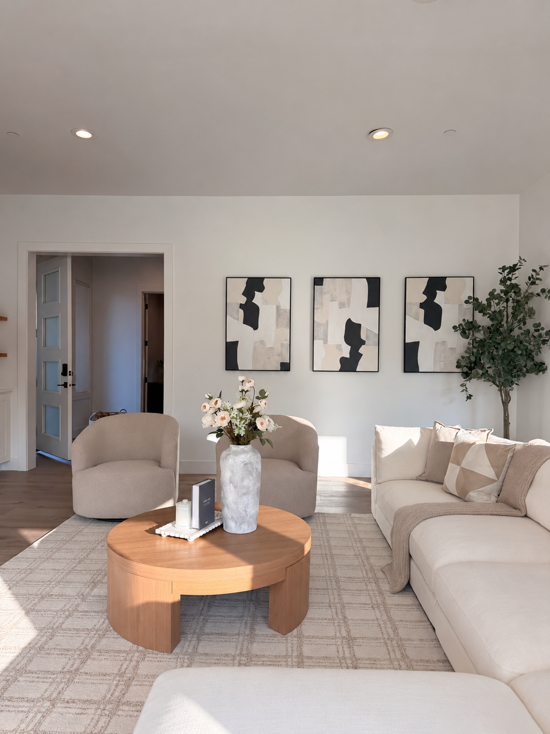 Living room with sculptural wood coffee table and soft chairs