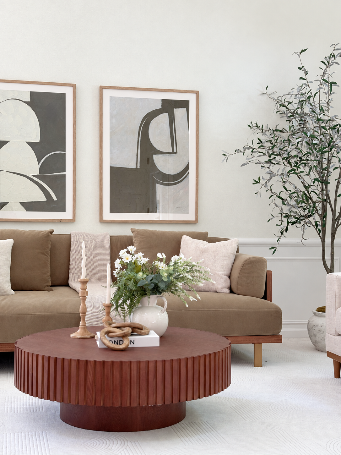 Olive sofa, abstract art, and low round table