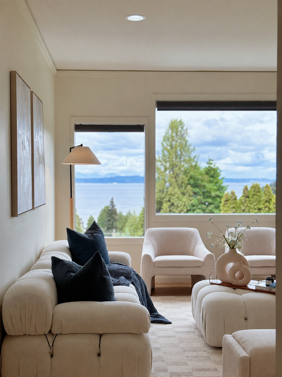 Living room with comfortable seating and expansive water views