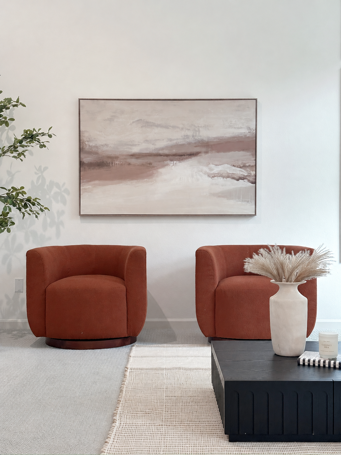 Pair of rust chairs beneath abstract painting