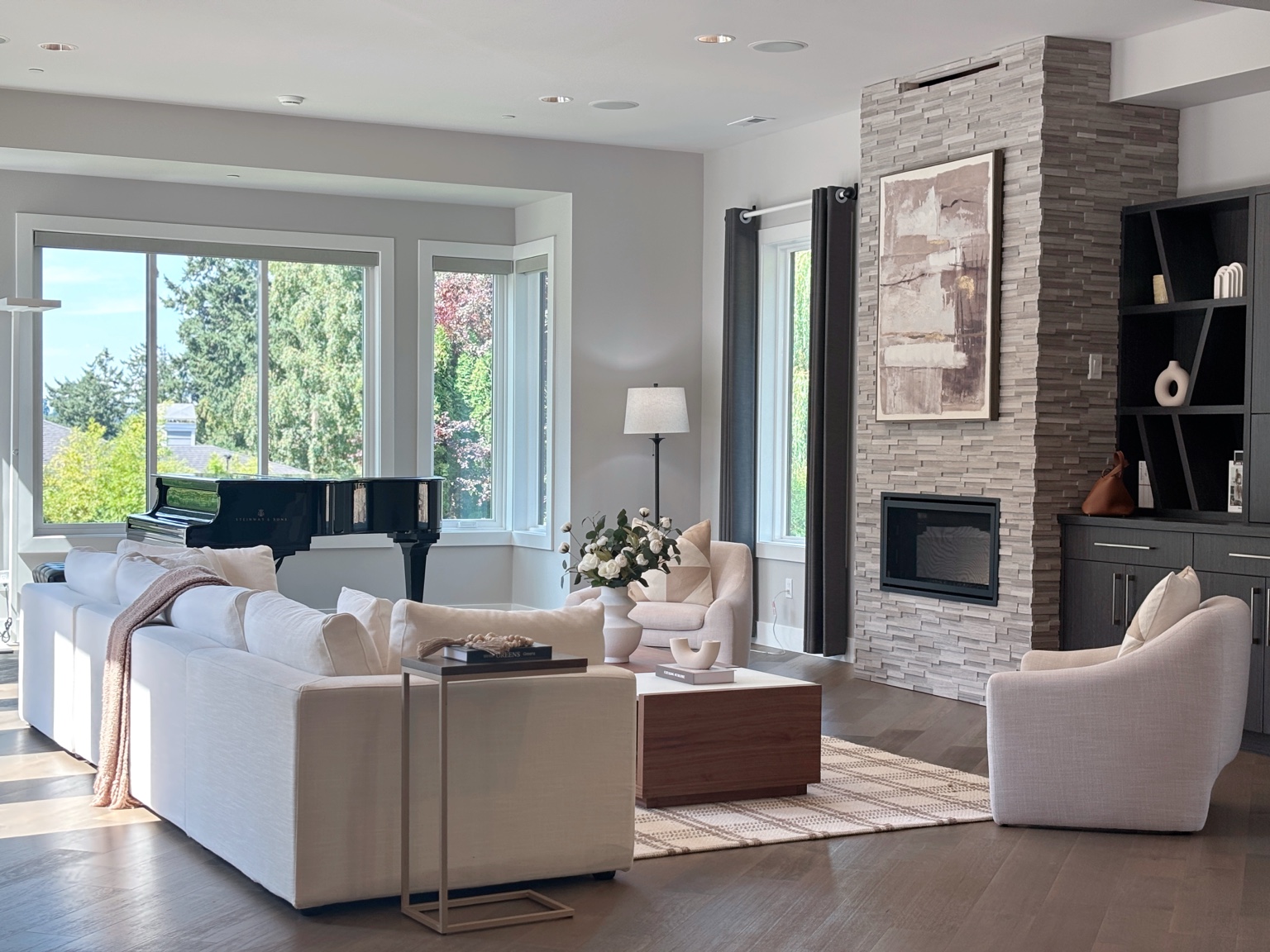 Furnished living room with grand piano and warm neutral seating