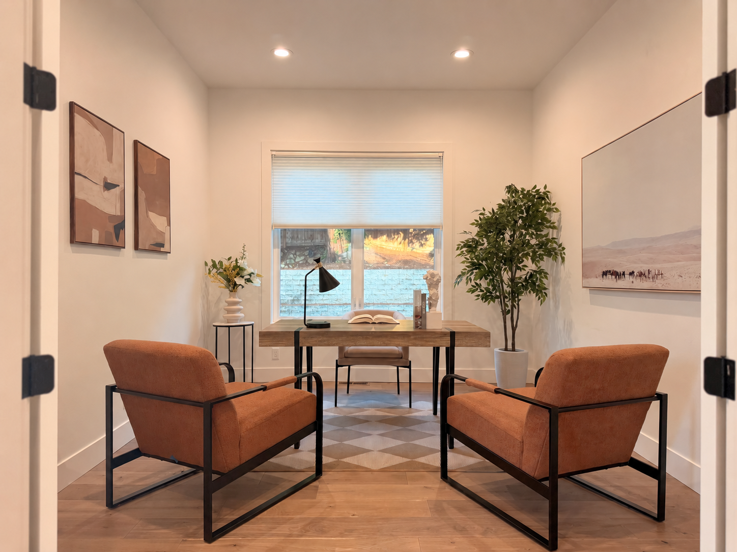 Home office with two rust chairs and wood desk