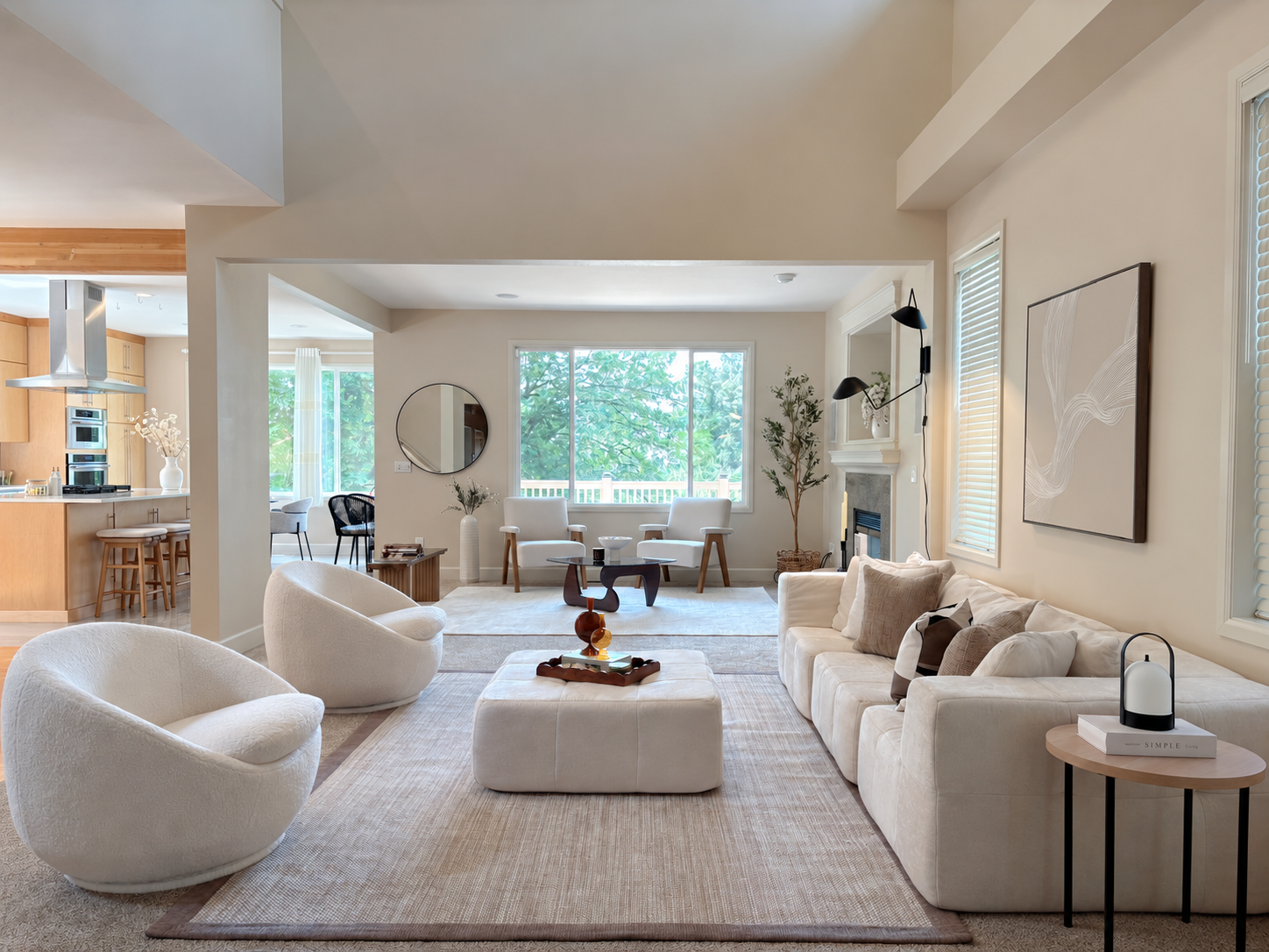 Open living room with cream seating, layered textiles and a sculptural coffee table